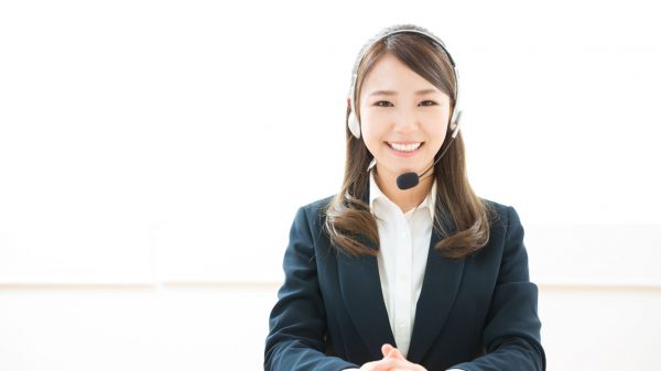 Asian woman with headset smiling