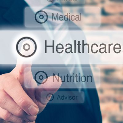 Man in suit pointing at Healthcare graphic